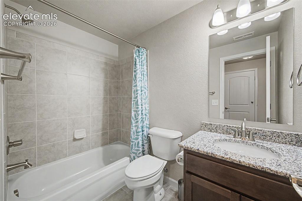 Image 23 of 28: Full bathroom between the basement bedrooms