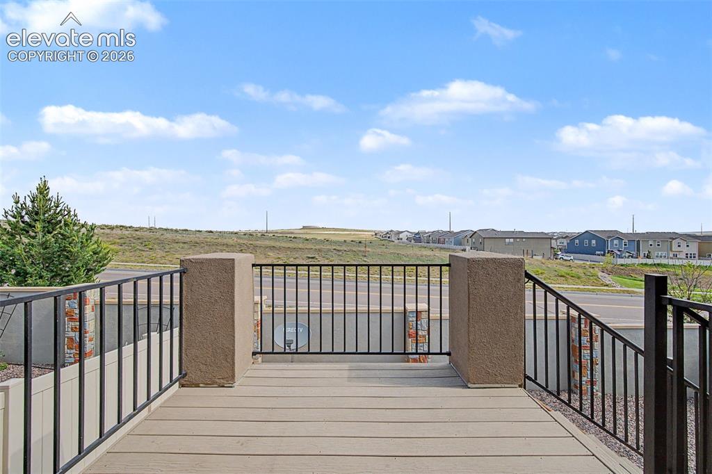 Image 25 of 28: Covered deck provides the perfect place to entertain or relax outdoors