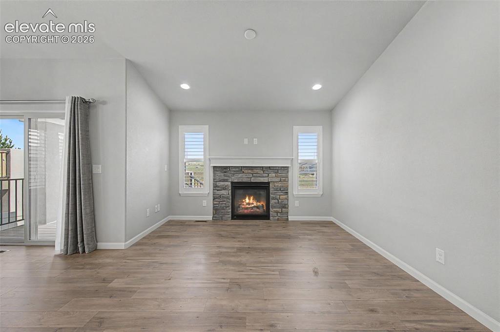 Image 5 of 28: Gorgeous luxury vinyl plank flooring and a cozy fireplace beckon you into t