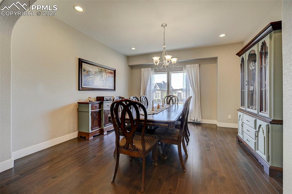 Image 14 of 50: Dining space featuring baseboards, dark wood-style flooring, an inviting ch