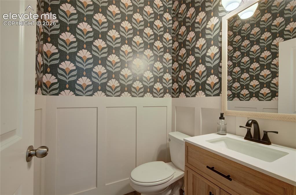 Image 15 of 35: Powder room featuring botanical print wallpaper, white board and batten wai