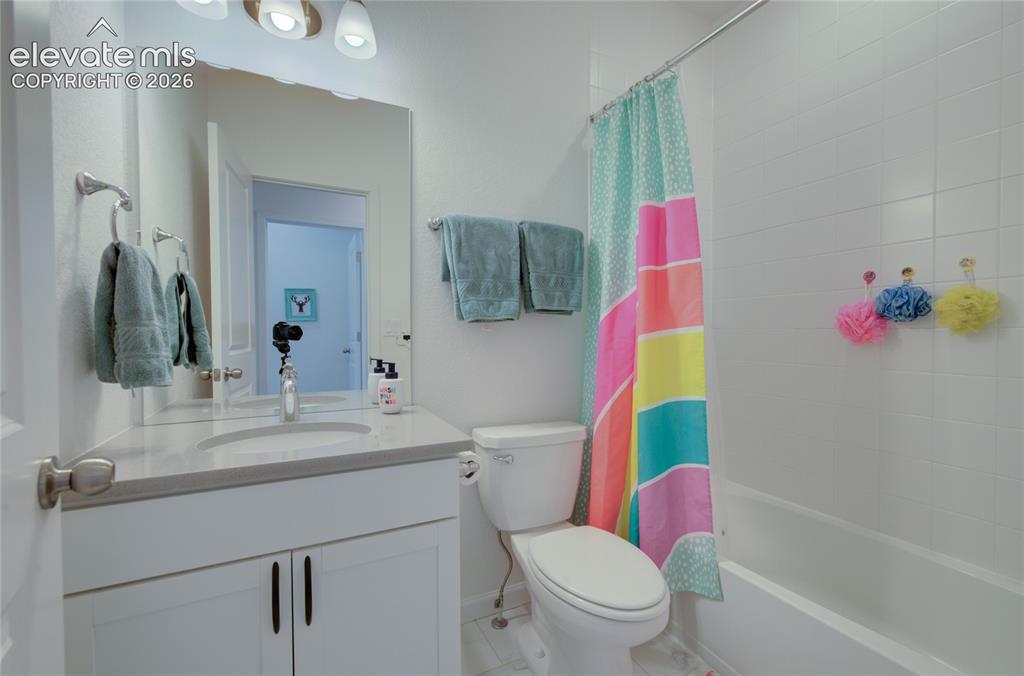 Image 19 of 35: Bathroom featuring a built-in vanity with a rectangular undermount sink, a 
