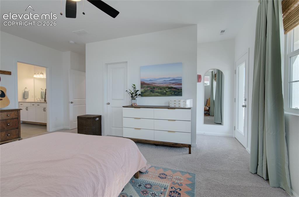 Image 22 of 35: Spacious room featuring light-colored carpeting, a ceiling fan, and white w
