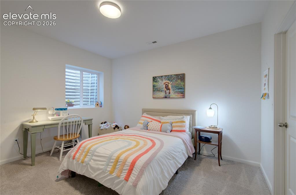 Image 31 of 35: Carpeted room featuring a window with a well-covered window well, a ceiling