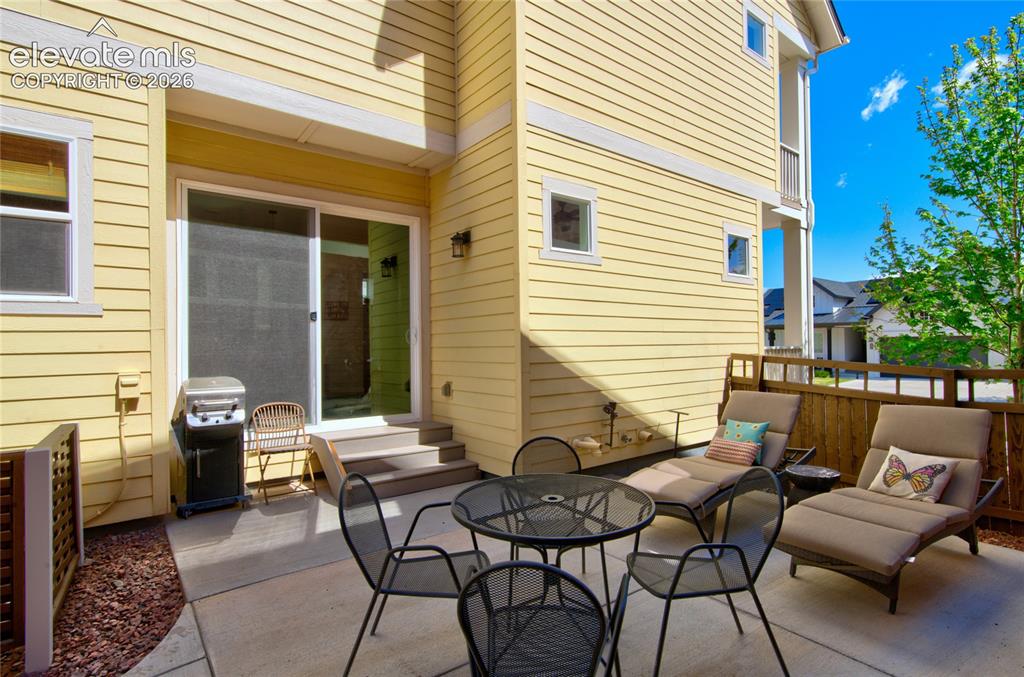 Image 33 of 35: Private concrete patio featuring direct outdoor access via sliding glass do