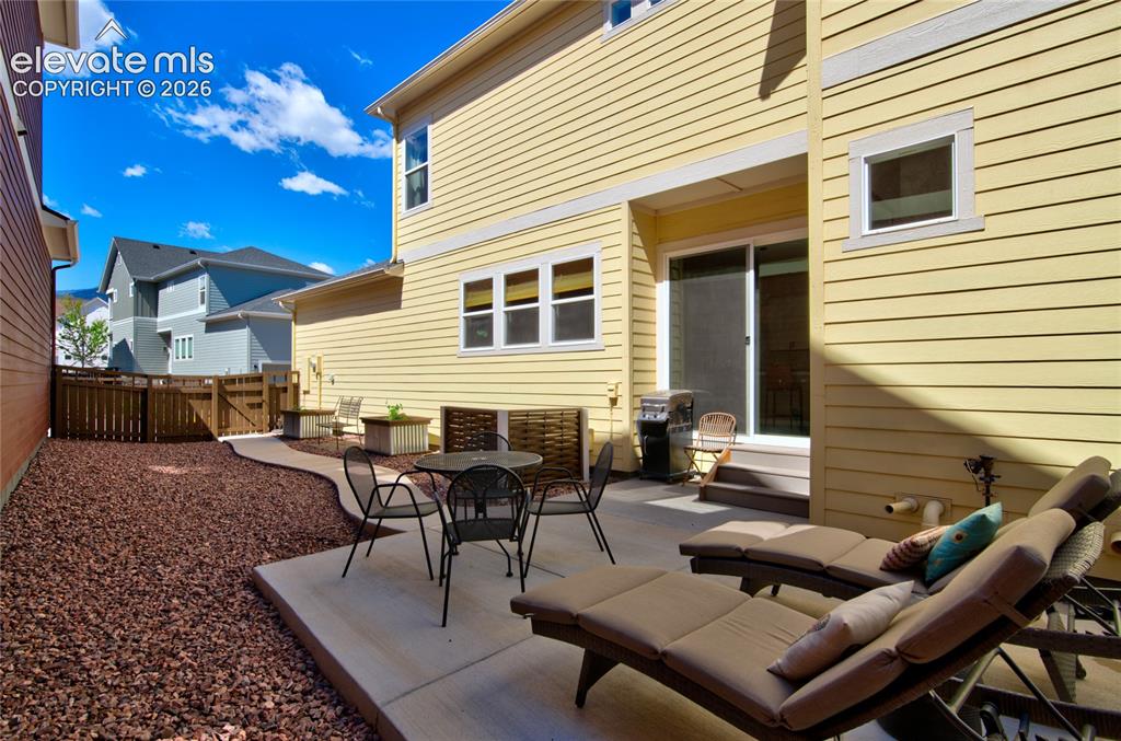 Image 34 of 35: Private outdoor living area featuring a concrete patio, sliding glass door 