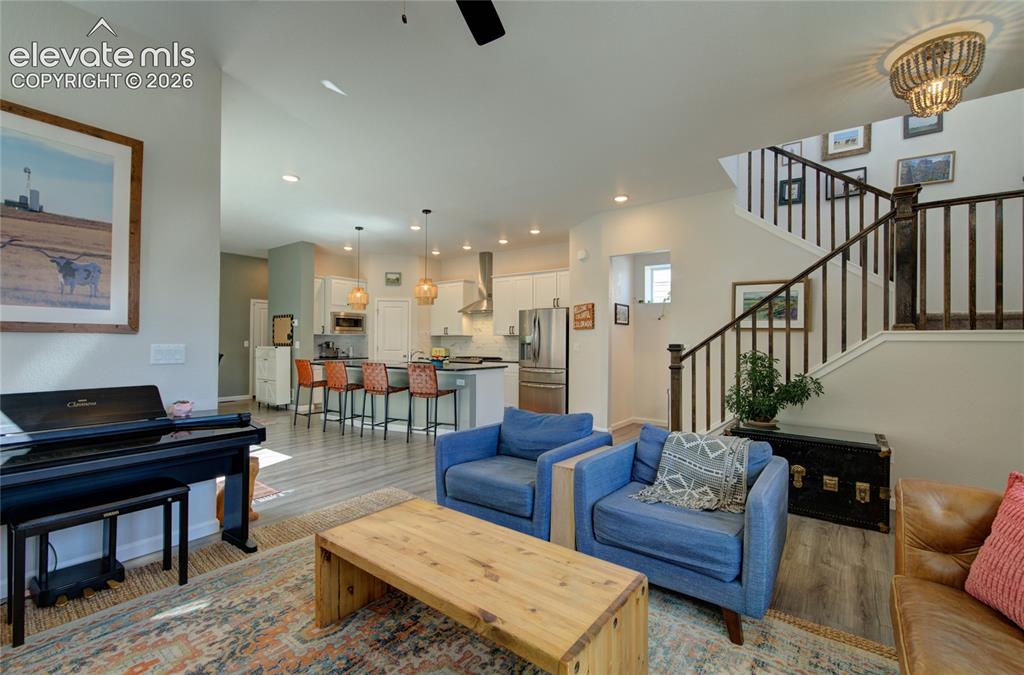 Image 7 of 35: Spacious open-concept living area featuring high ceilings, wood-finish floo