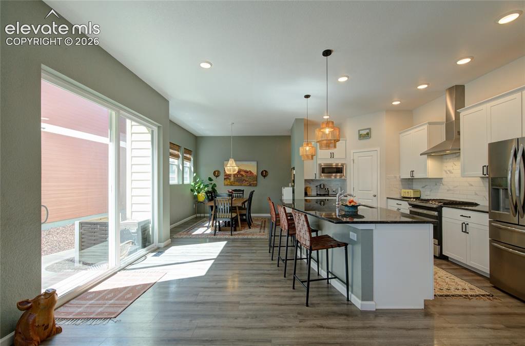 Image 8 of 35: Open concept living space featuring wood-finish flooring