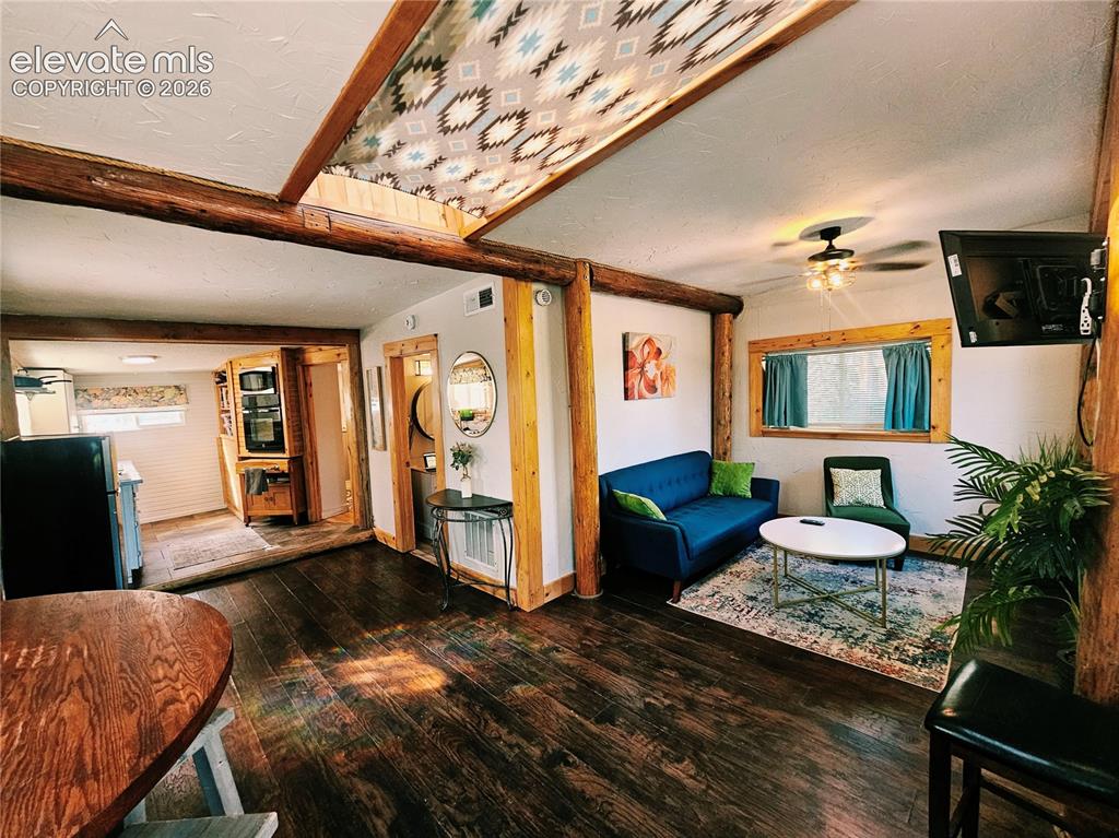 Image 11 of 37: Exposed wood beams, recessed lighting, ceiling fan light fixture, and a kit