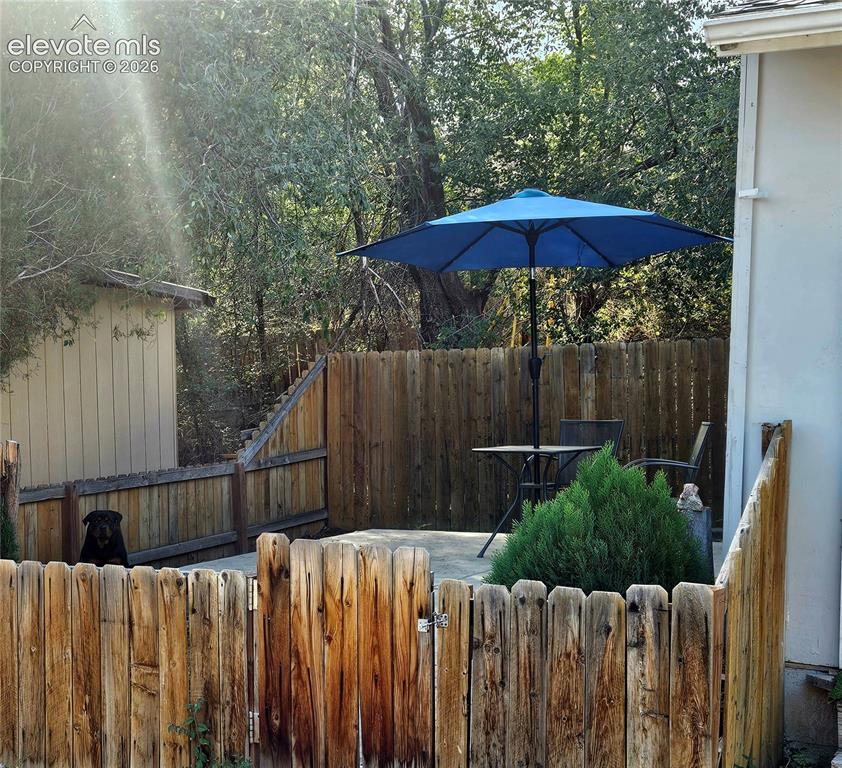 Image 35 of 37: Unit B private patio with fenced yard