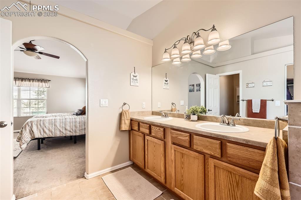 Image 14 of 49: Primary ensuite bathroom, double vanity and tile flooring