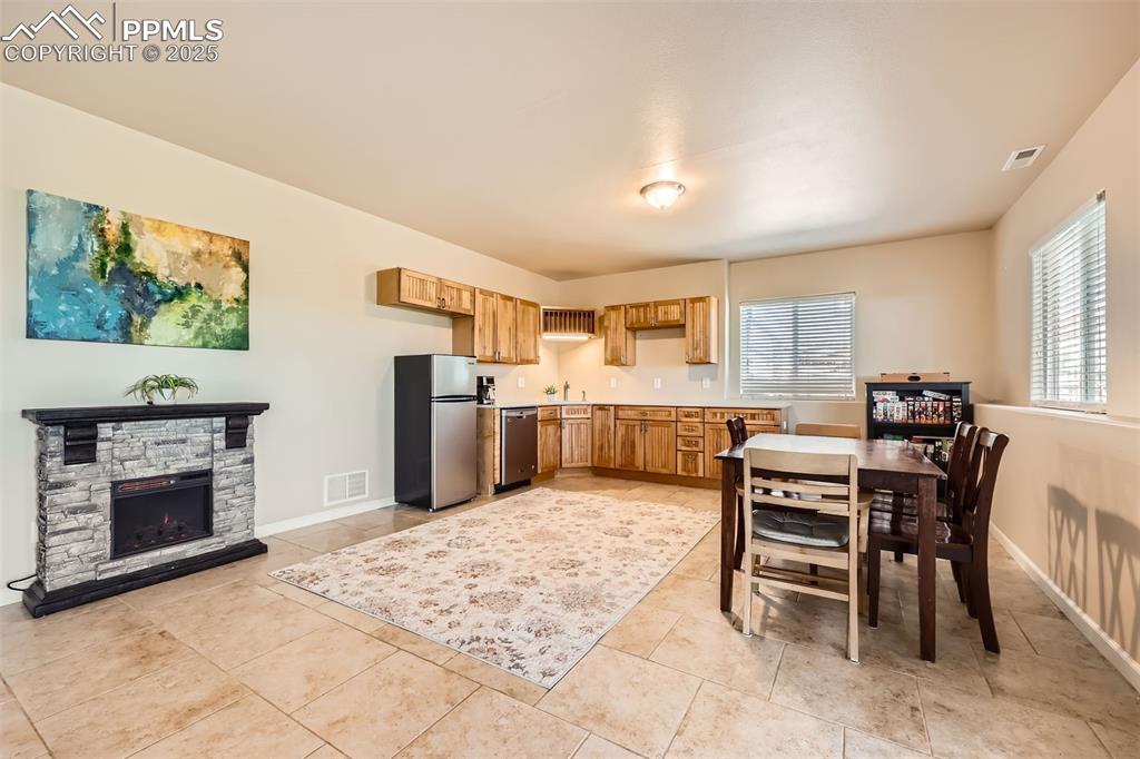 Image 21 of 49: Kitchen with stainless steel appliances and light countertops