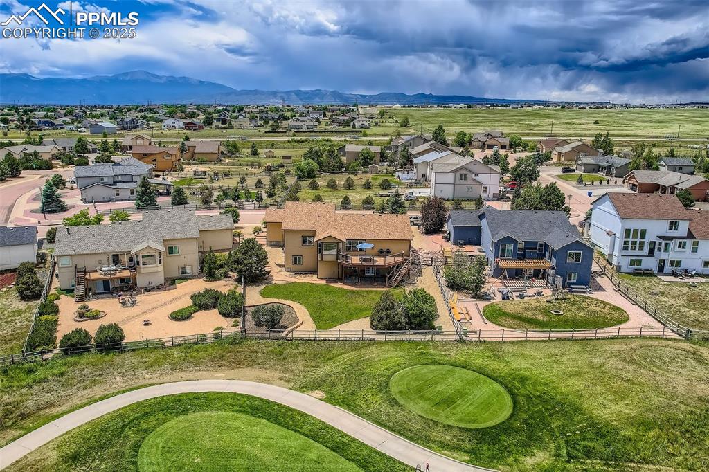 Image 32 of 49: Aerial perspective of suburban area featuring a mountain backdrop