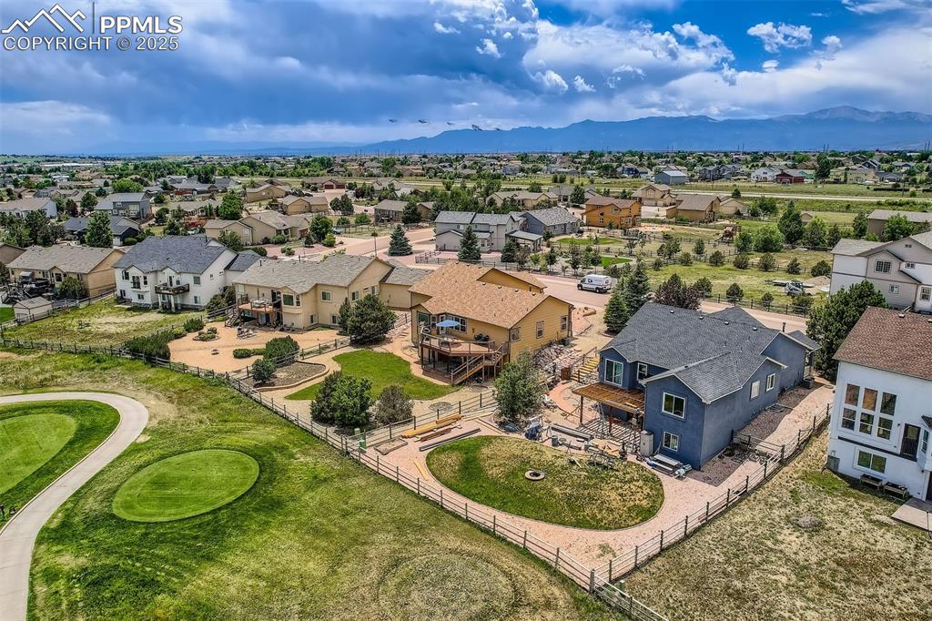 Image 36 of 49: Aerial perspective of suburban area featuring mountains