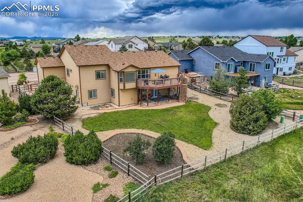 Image 38 of 49: Rear view of house and backyard