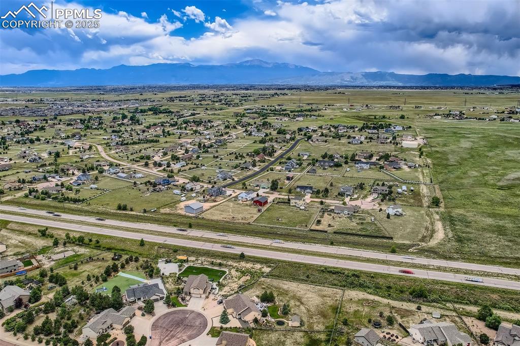 Image 39 of 49: Aerial perspective of suburban area featuring a mountain backdrop