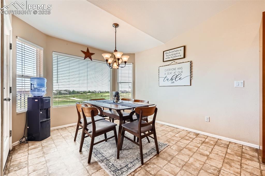 Image 9 of 49: Dining room with chandelier walks out to deck