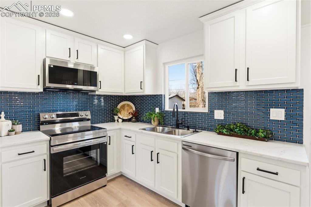 Image 9 of 37: Updated kitchen with modern finishes, perfect for cooking and hosting