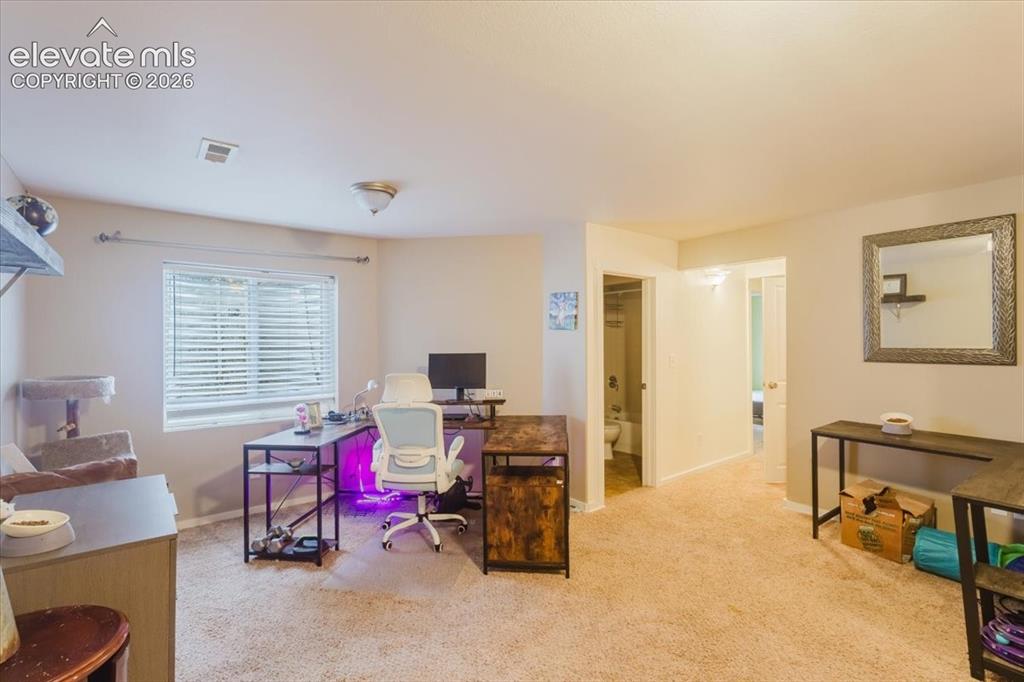 Image 18 of 33: Second primary bedroom upstairs with attached bath and walk-in closet