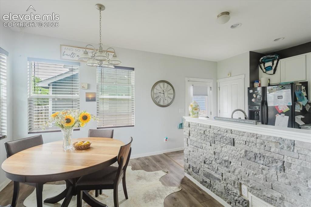 Image 5 of 33: Bright living room with window views of Pikes Peak