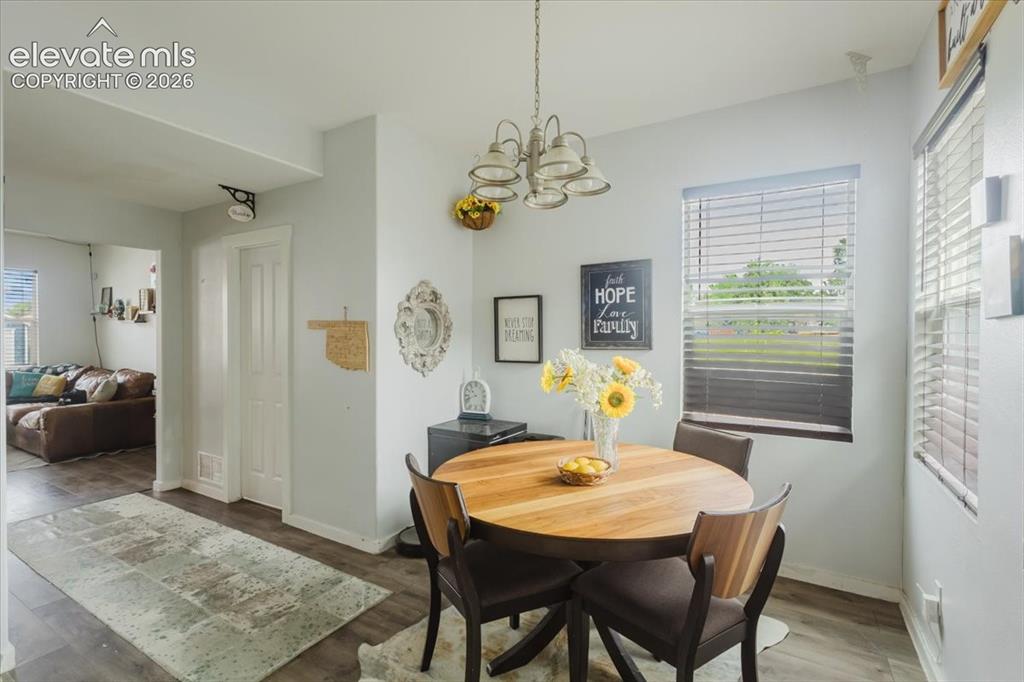 Image 8 of 33: Dining area with back yard and garage access. Pantry in kitchen.