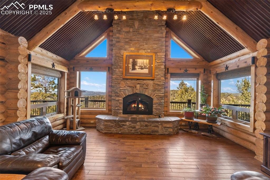 Image 11 of 46: Living area featuring hardwood / wood-style floors, an outdoor stone firepl