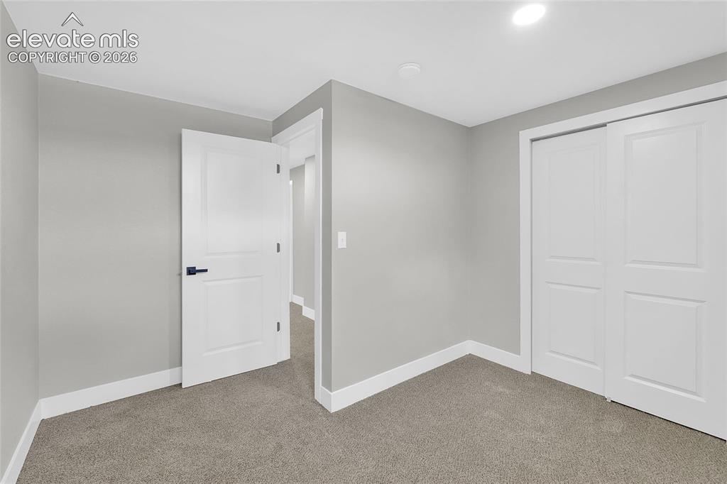 Image 21 of 27: Light gray wall paint, recessed ceiling lighting, two-panel interior doors 