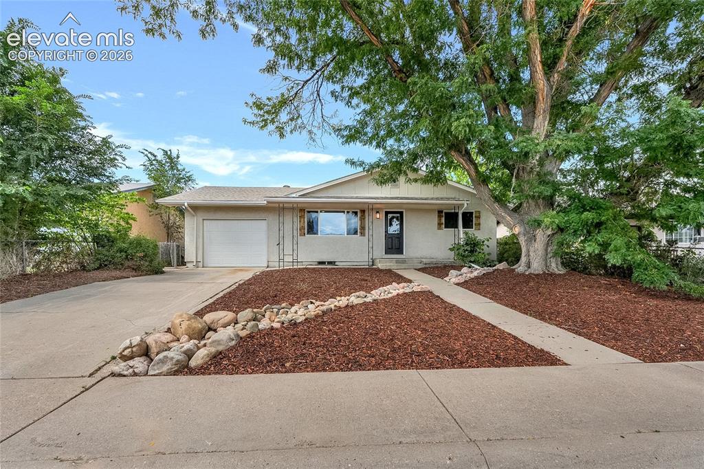Image 3 of 27: Single-story residence featuring a concrete driveway, attached garage, and