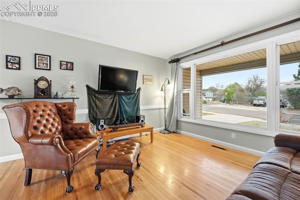 Image 10 of 47: Living area featuring light wood-type flooring and baseboards