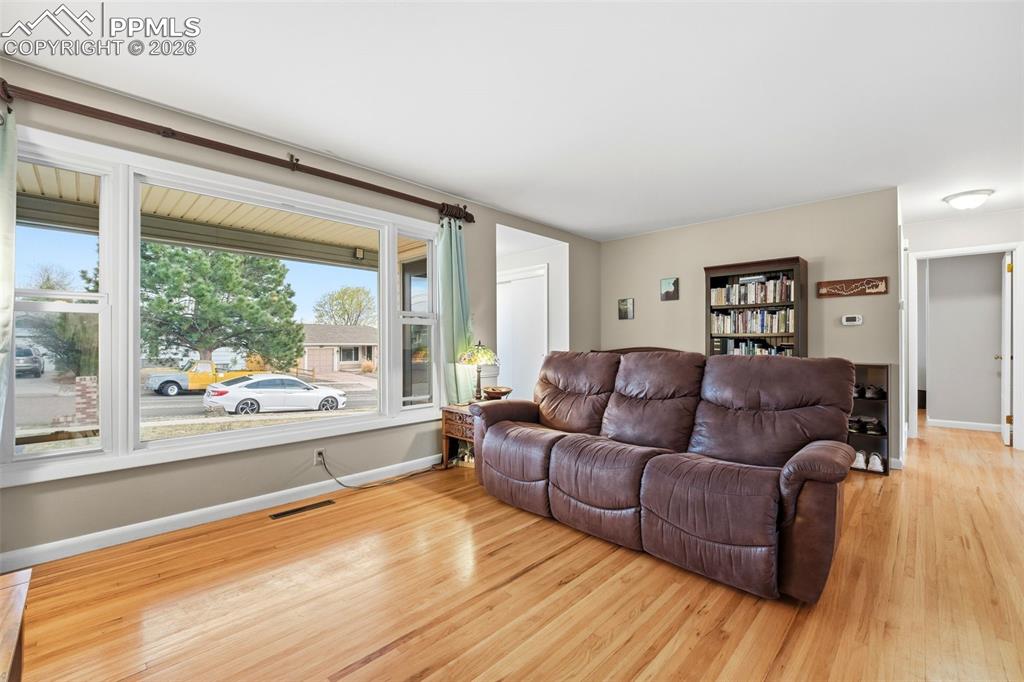 Image 11 of 47: Living area with light wood-type flooring and baseboards