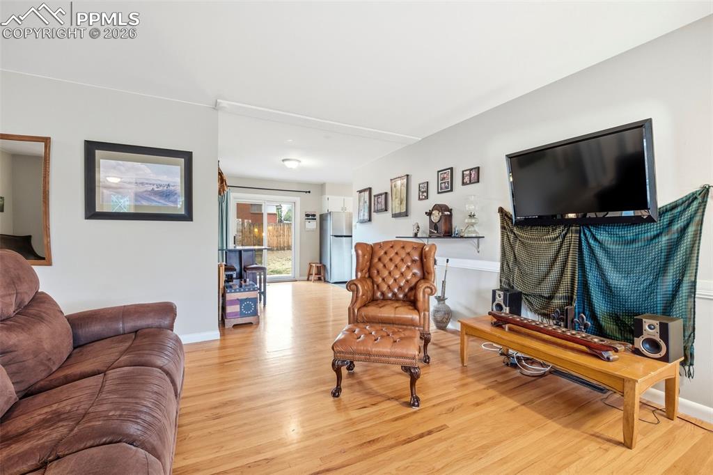 Image 13 of 47: Living area with light wood-style flooring
