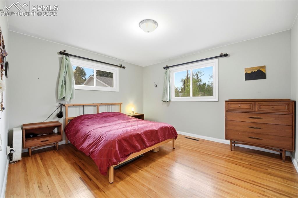 Image 16 of 47: Bedroom with light wood-style flooring and baseboards