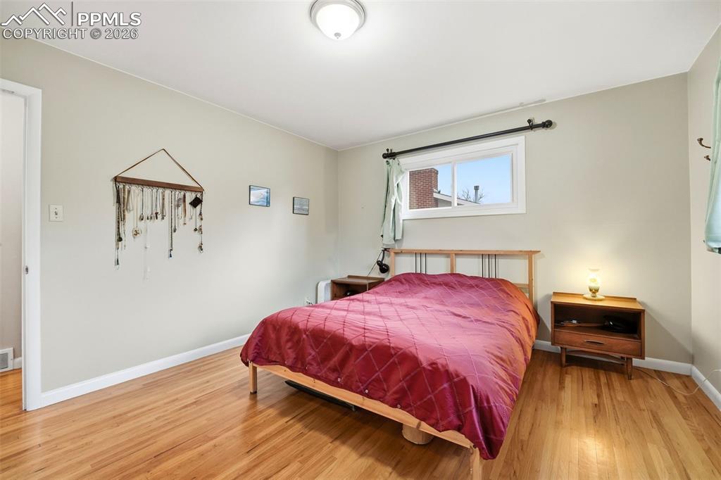 Image 18 of 47: Bedroom with baseboards and light wood-type flooring
