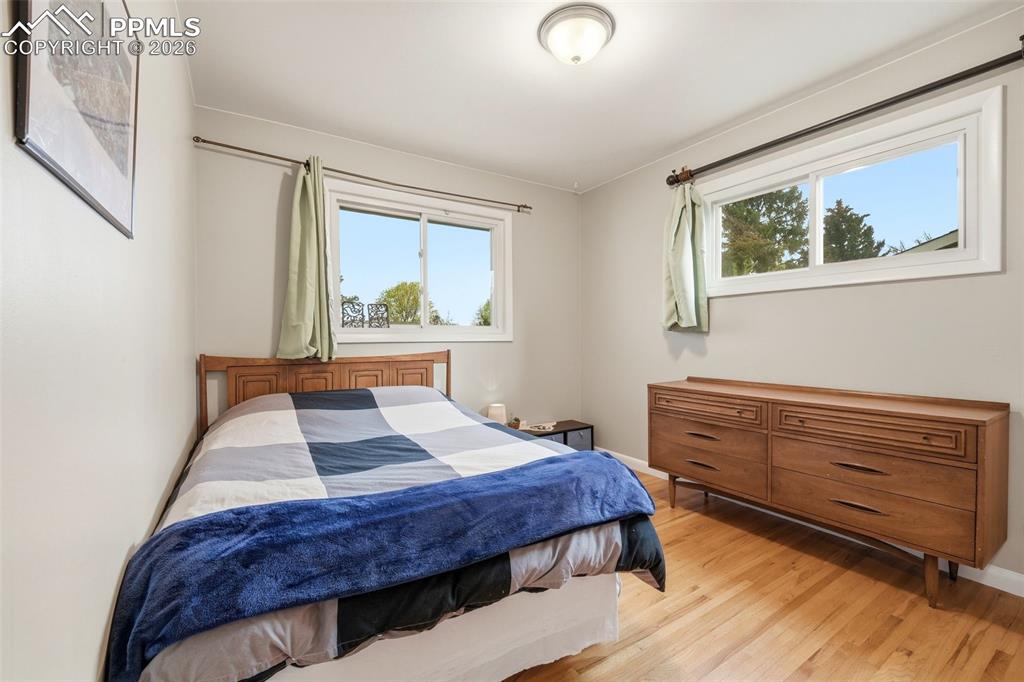 Image 20 of 47: Bedroom with light wood-type flooring and multiple windows