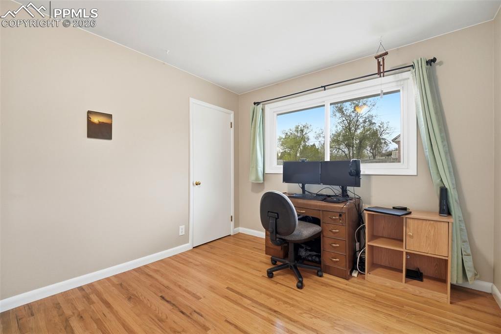 Image 23 of 47: Office space with baseboards and light wood-style flooring