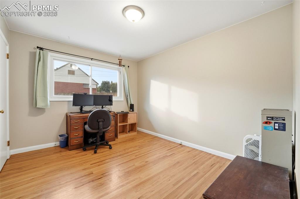 Image 24 of 47: Home office featuring baseboards and light wood-style floors