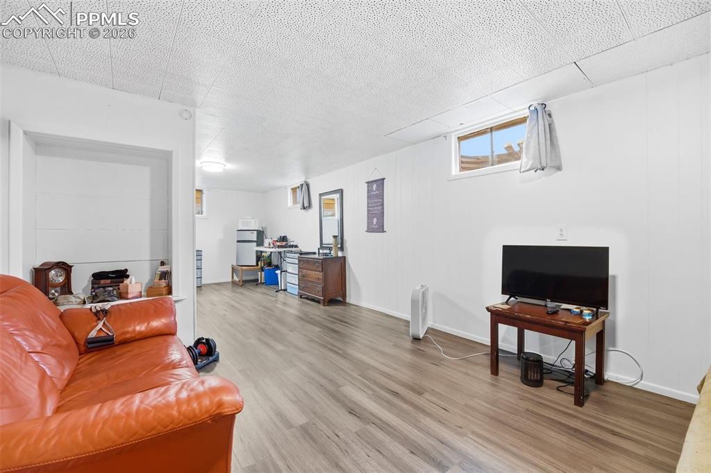 Image 25 of 47: Living area with light wood finished floors and baseboards