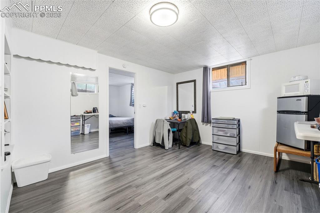 Image 29 of 47: Office featuring dark wood-style flooring and healthy amount of natural lig