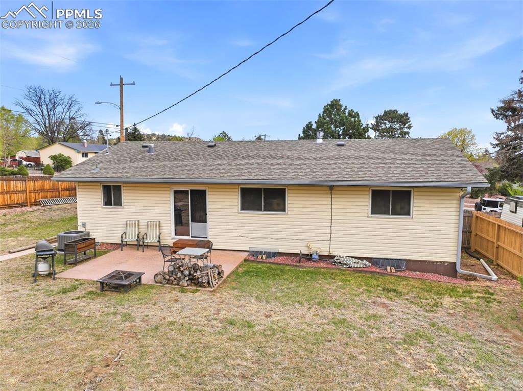 Image 37 of 47: Rear view of house with a fenced backyard, a patio, a shingled roof, and a 