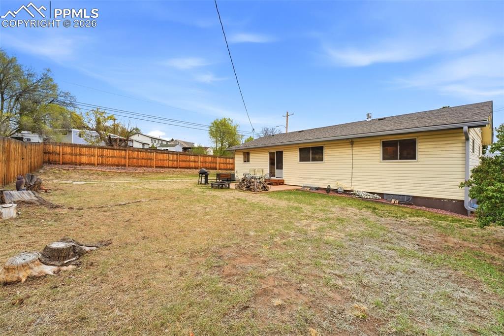 Image 38 of 47: Rear view of house with a patio and a fenced backyard