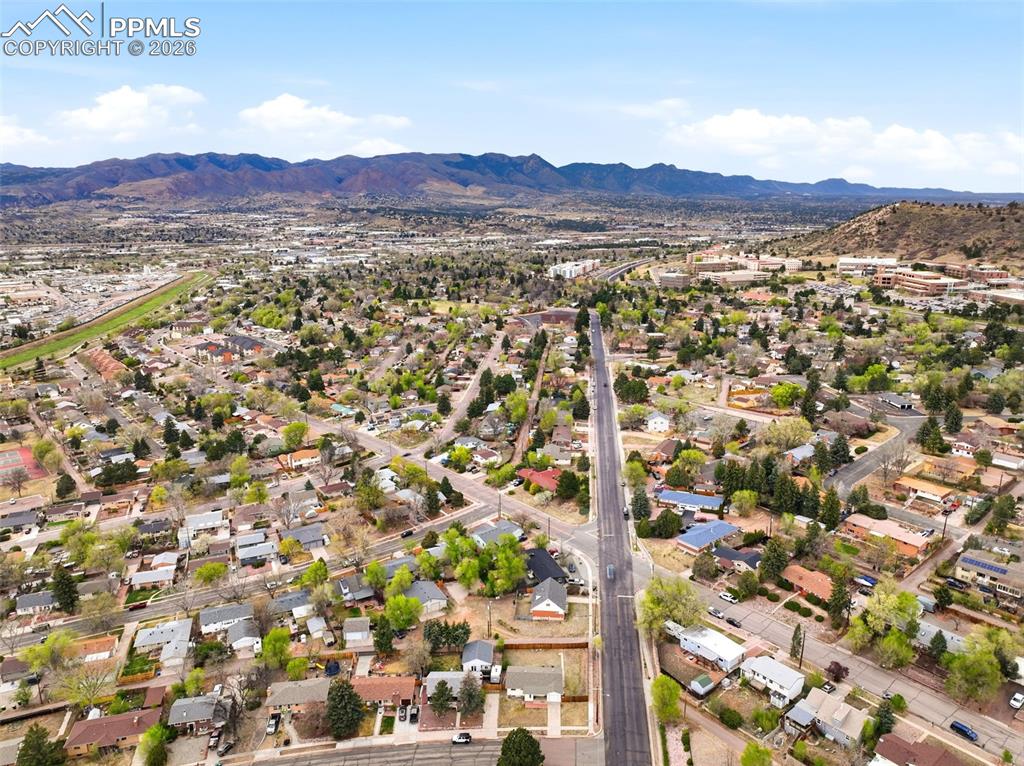 Image 40 of 47: Aerial perspective of suburban area with a mountainous background