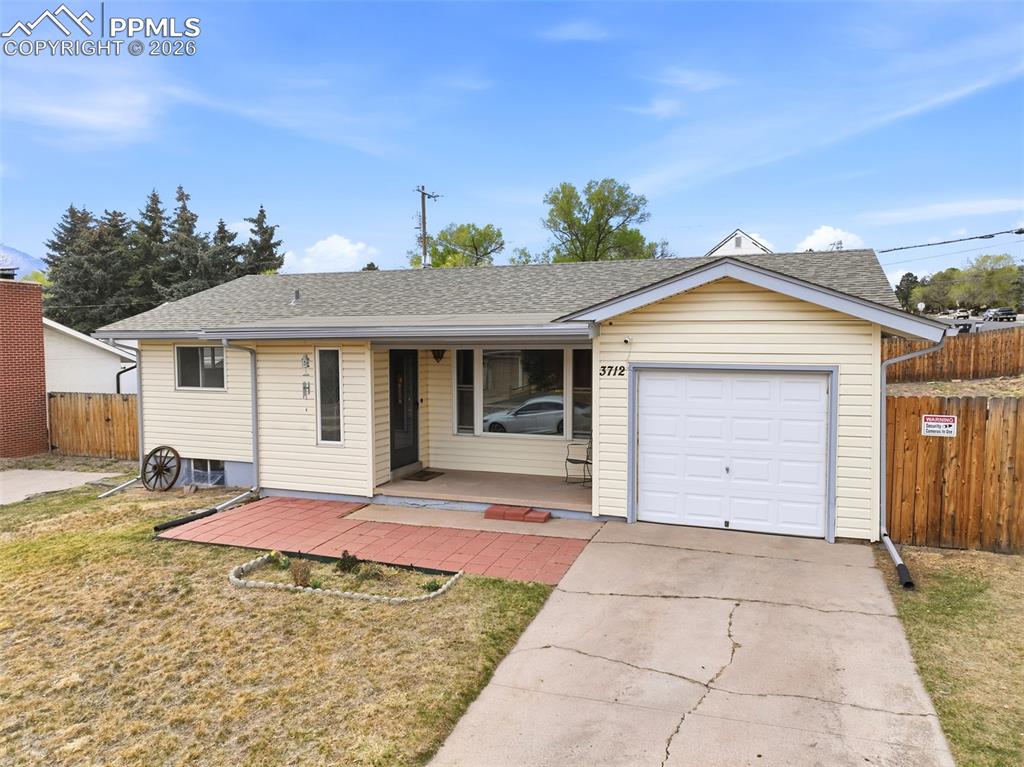 Image 43 of 47: Ranch-style home with a garage, roof with shingles, and driveway
