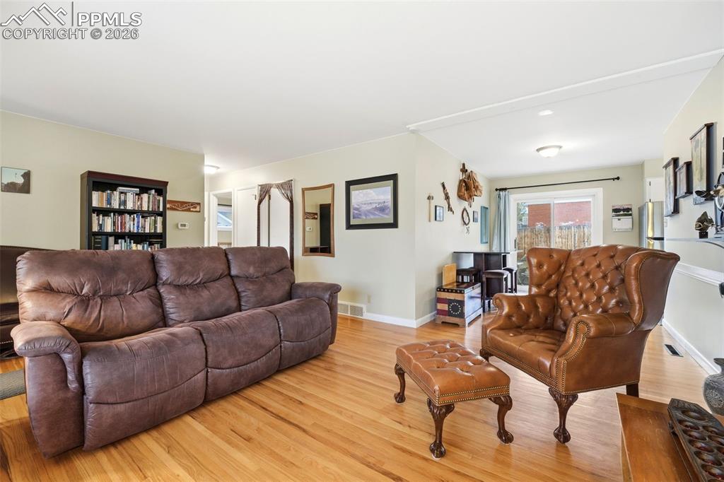 Image 9 of 47: Living area featuring light wood-style flooring