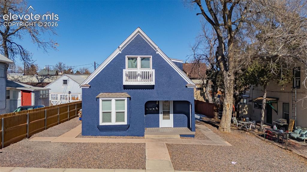 Image 1 of 33: View of front facade featuring a patio area, a fenced backyard, a balcony,