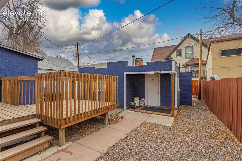 Image 19 of 33: Back of property with a deck