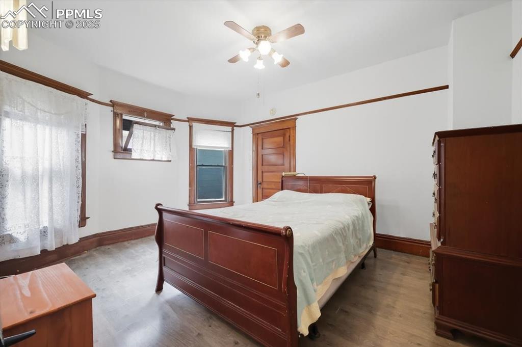 Image 11 of 23: Bedroom featuring wood finished floors and a ceiling fan