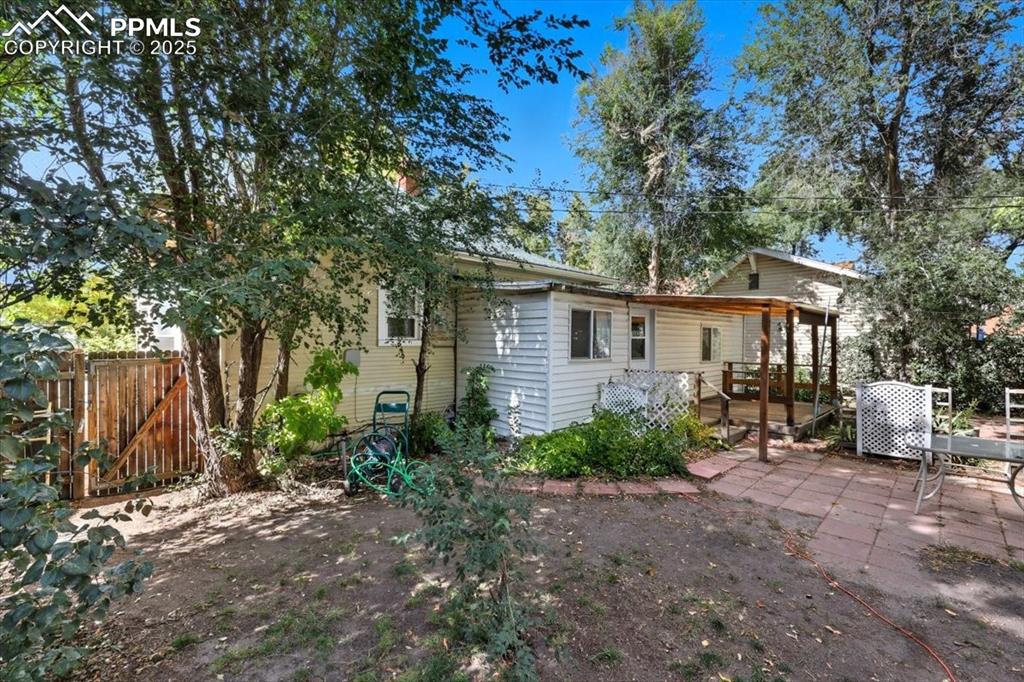 Image 17 of 23: Back of house with a wooden deck