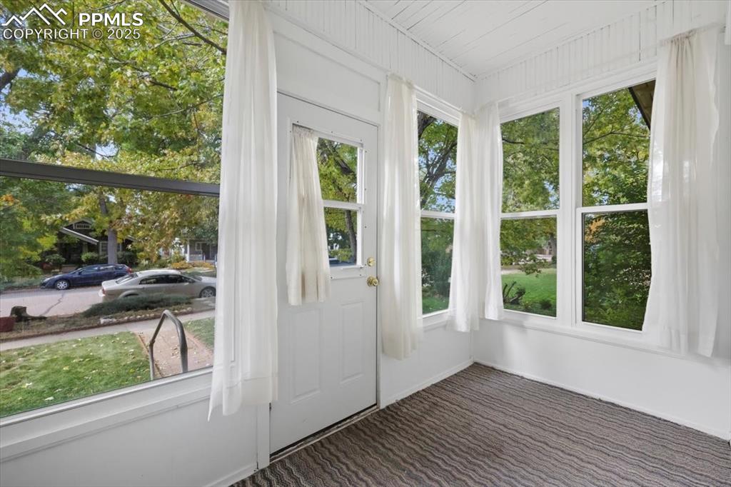 Image 2 of 23: Unfurnished sunroom featuring carpet floors and baseboards