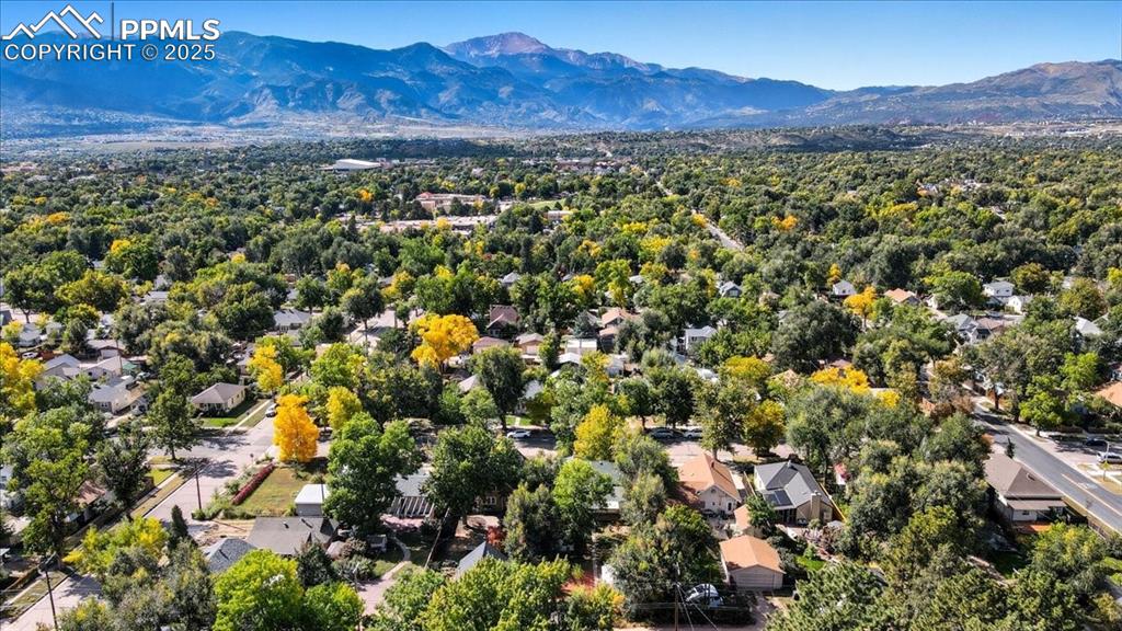 Image 22 of 23: Aerial view of residential area featuring a mountainous background