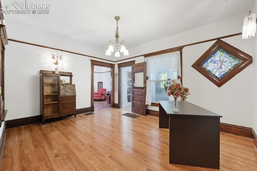 Image 5 of 23: Entrance foyer featuring a chandelier and light wood finished floors